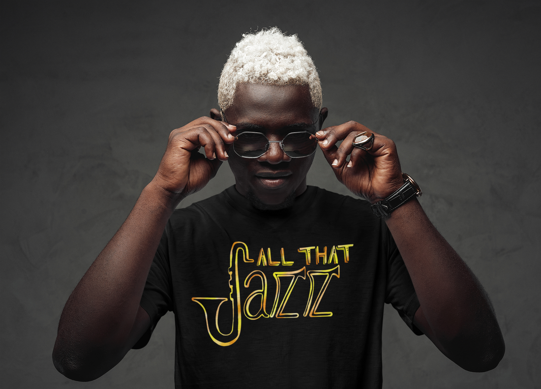 A male with sunglasses wearing a black music Tshirt with the text "All that jazz". The text is in vivid golden colors