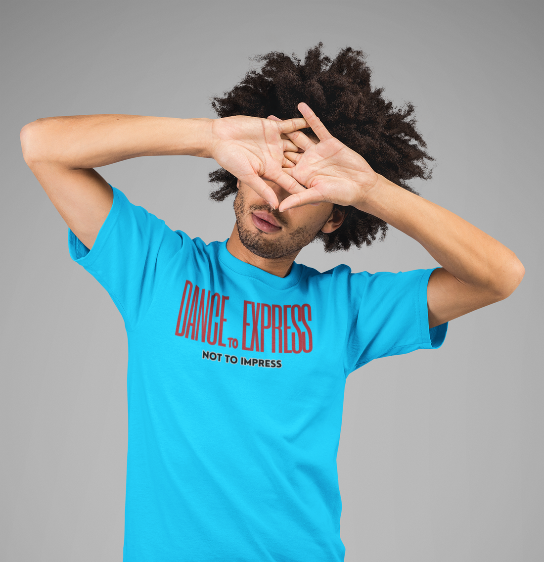 A male wearing a light blue T-shirt with the text "dance to express not to impress"