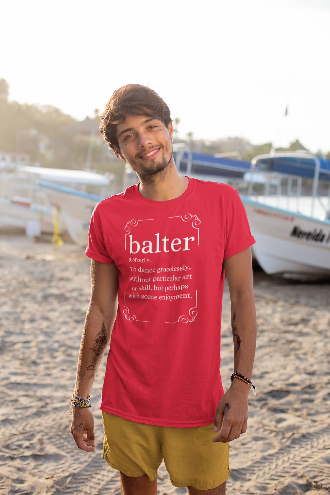 A male wearing a red music tshirt design with the text "Balter, To dance gracelessly without particular art or skill but perhaps with some enjoyment" and retro graphics surrounding it.