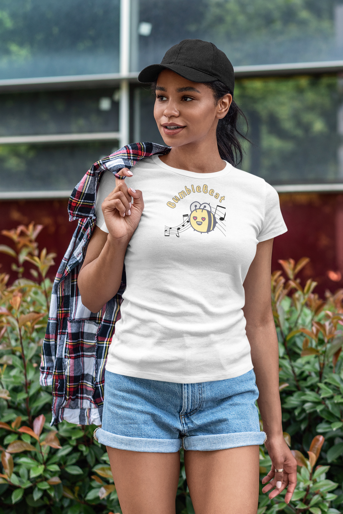 A female wearing a white T-shirt with the text "bumblebeat" and a bumblebee buzzing to music