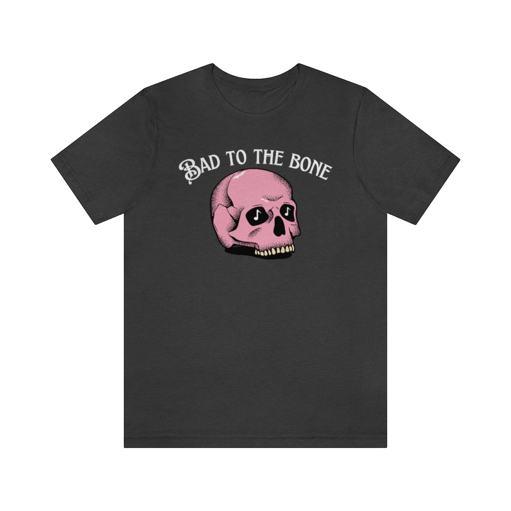 T-shirt with the text "bad to the bone" and a cartoony pink skull beneath it  having music notes in its eye sockets.