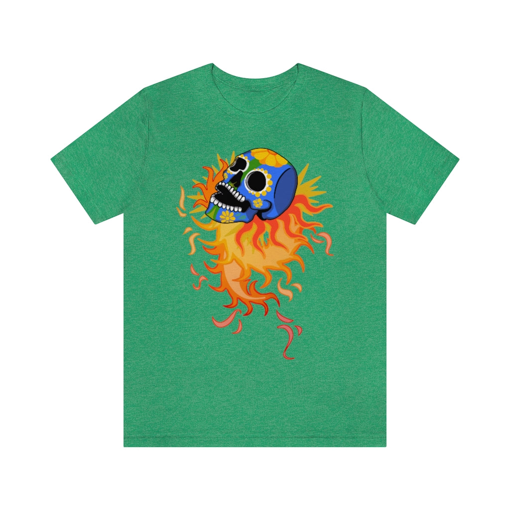A green T-shirt with a mexican alibrije style dia del muerte skull. It is traveling and leaves behind a spiral of fire.