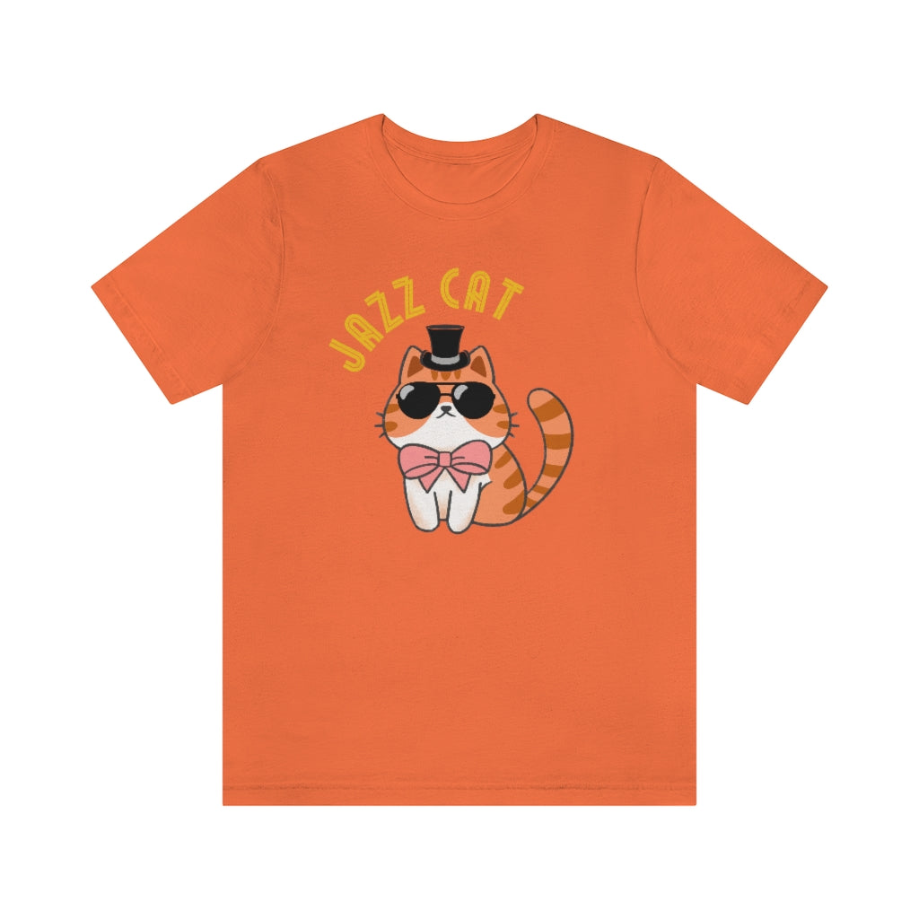 An orange T-shirt with a really cool cat. It's wearing black sunglasses, a top hat and a pink bowtie. Above it is the text "Jazz cat" in a very retro font.