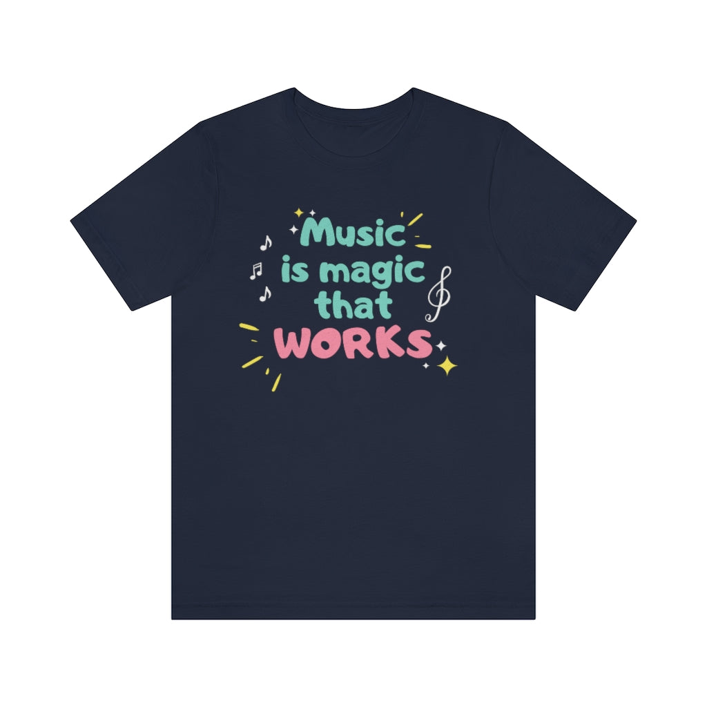 A dark blue T-shirt with the text "music is magic that works!". It has a childish and playful design with music notes and treble clefs surrounding it.