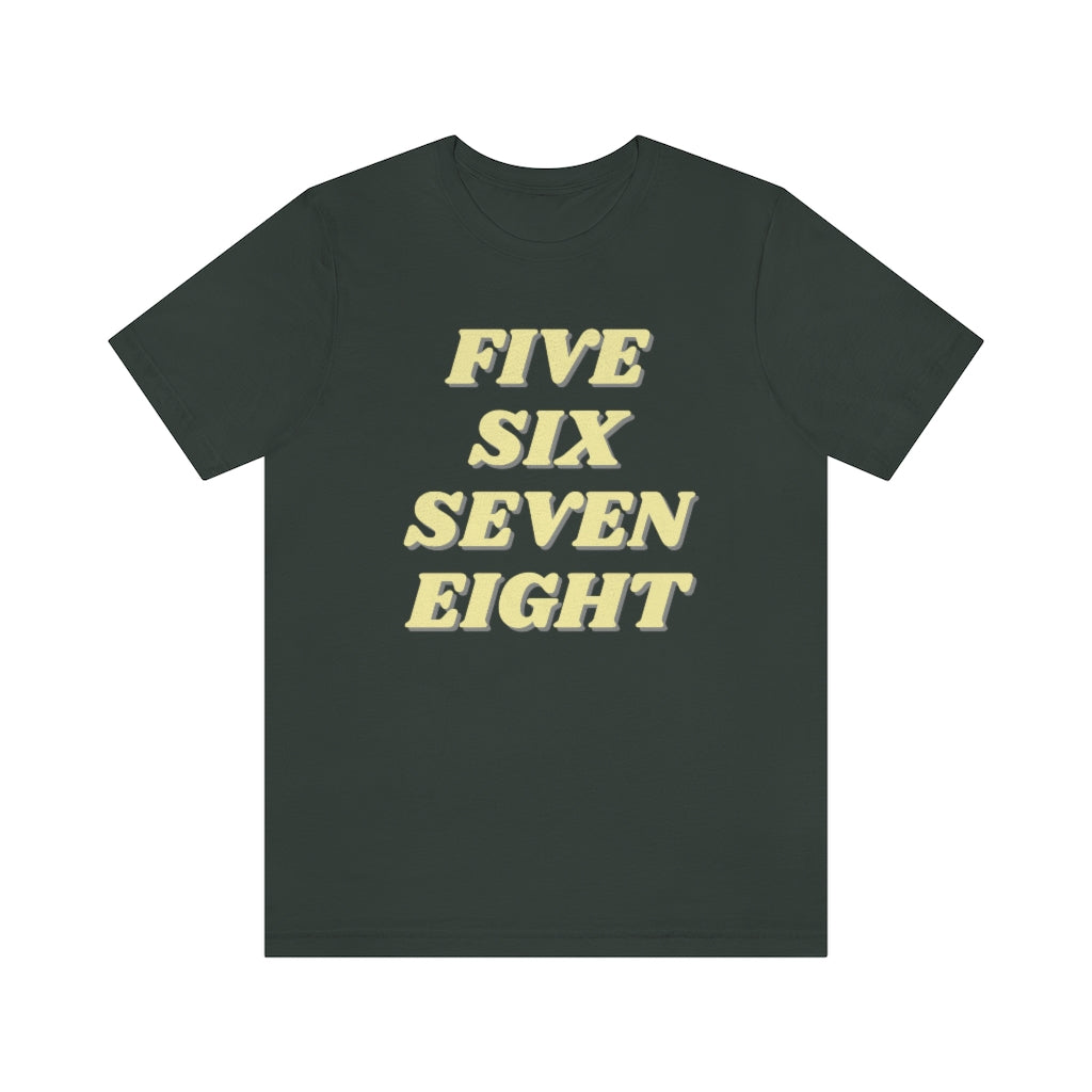 A grey T-shirt with the text "five sixe seven eight" in yellow text. It refers to the counting in of either music or dance.