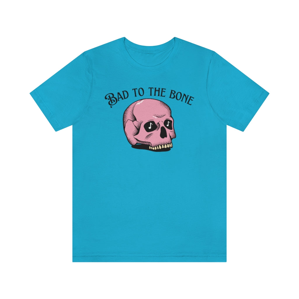 A bright blue T-shirt with the text "bad to the bone" and a cartoony pink skull beneath it  having music notes in its eye sockets.