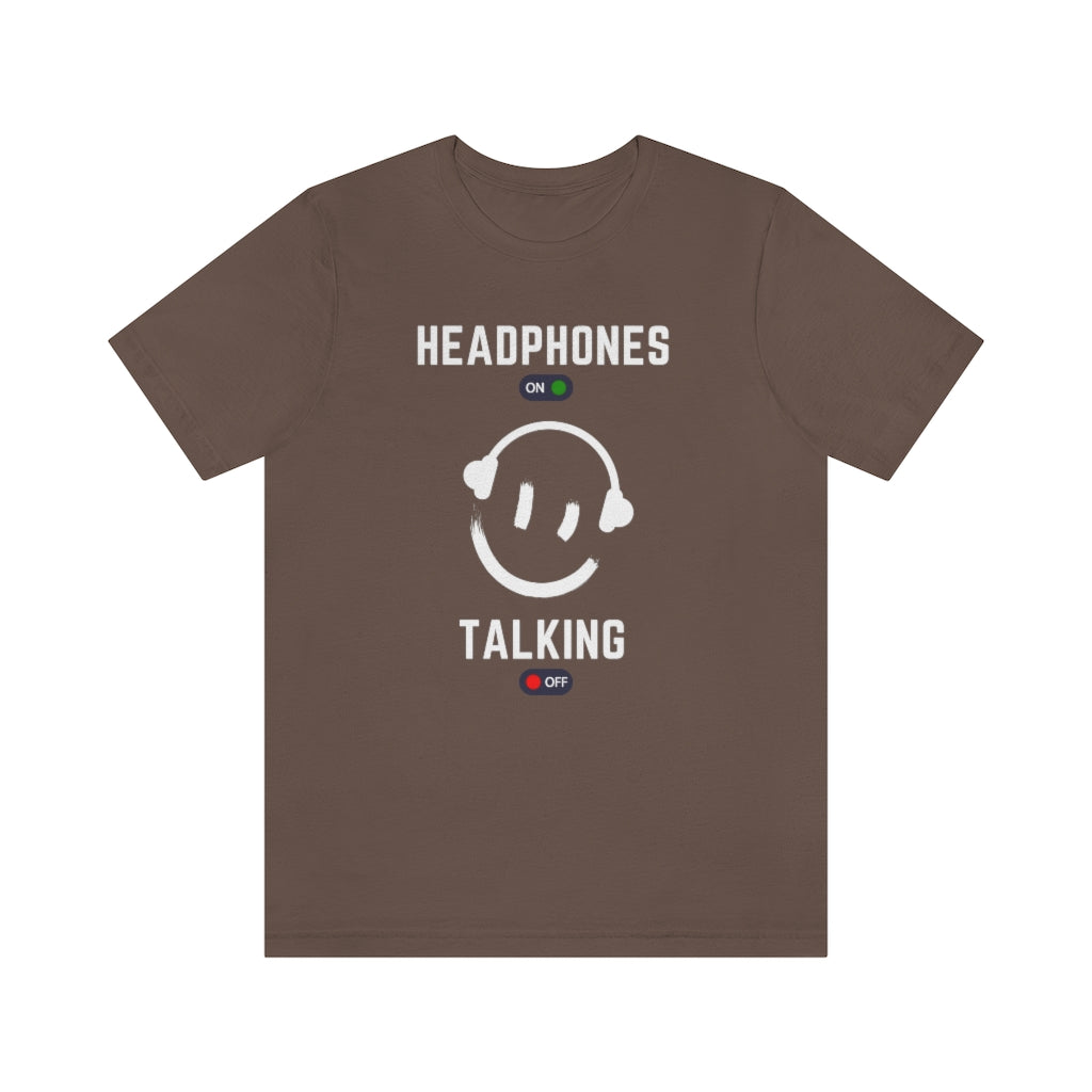 A brown T-shirt with a smiley wearing headphones. it has the text "Headphones on talking off" on it.