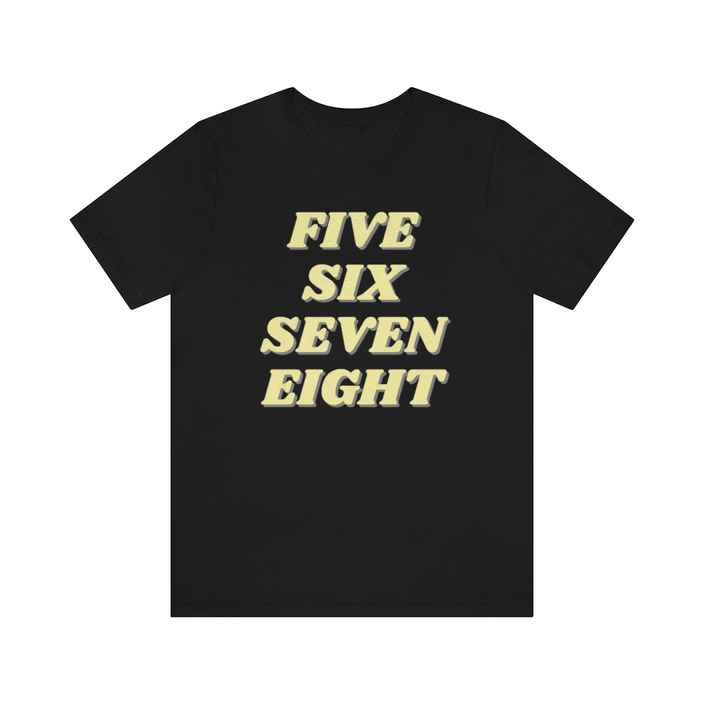 A black T-shirt with the text "five sixe seven eight" in yellow text. It refers to the counting in of either music or dance.