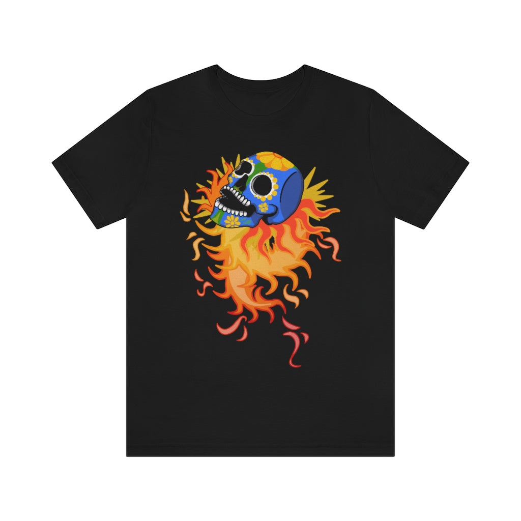 A black T-shirt with a mexican alibrije style dia del muerte skull. It is traveling and leaves behind a spiral of fire.