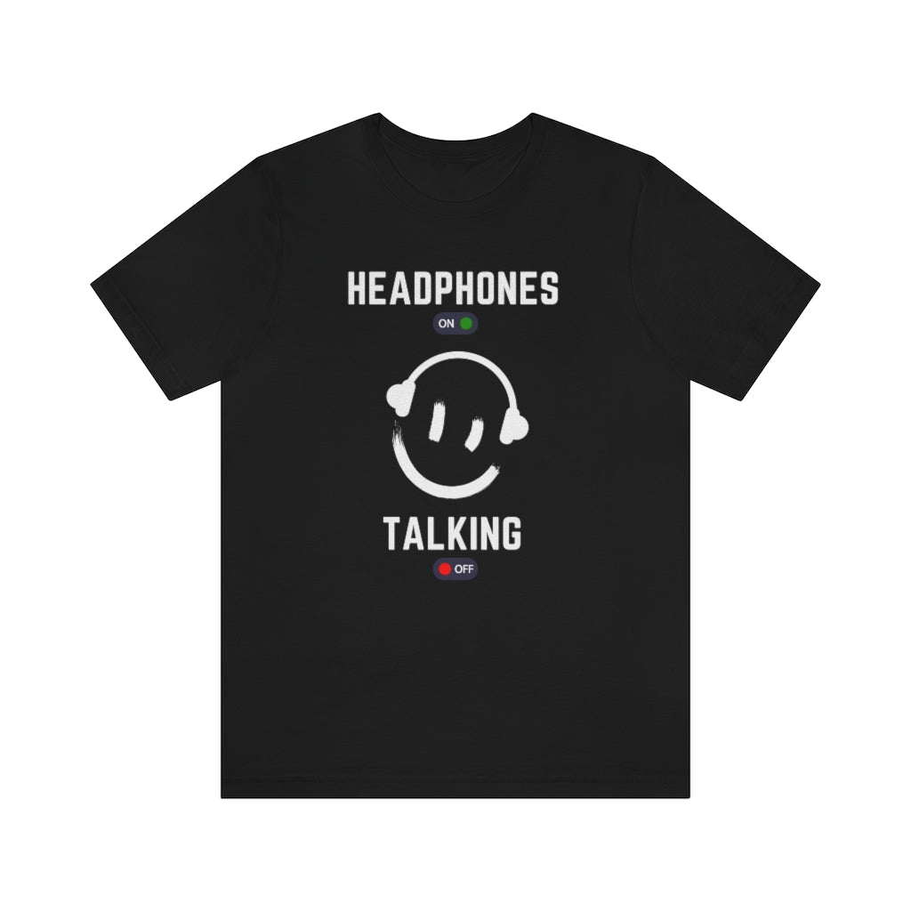 A black T-shirt with a smiley wearing headphones. it has the text "Headphones on talking off" on it.