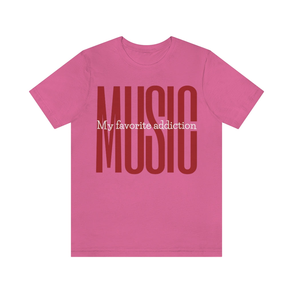 A pink A green T-shirt with large red and bold text saying "MUSIC". In the middle of it is the white text "My favorite addiction".